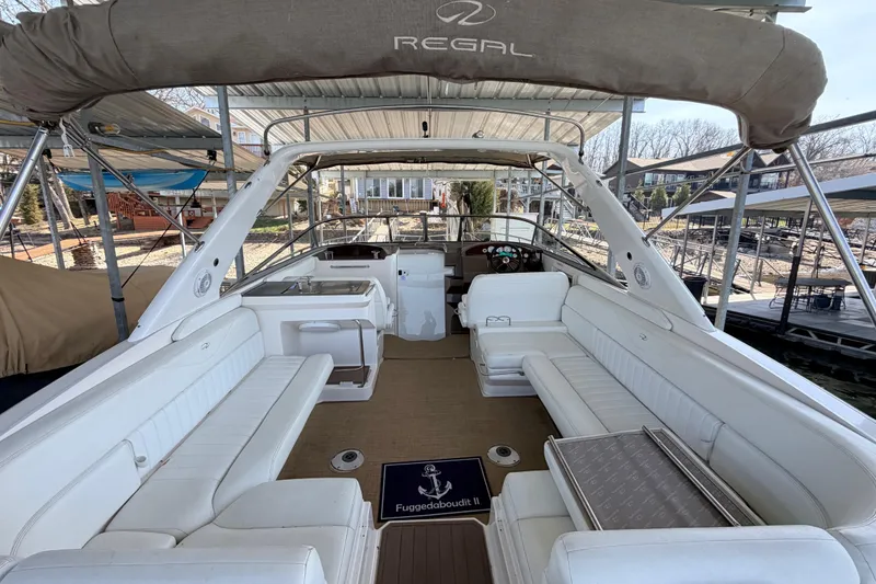 Slide: The Image of 2005 Regal 3350 Sport Cruiser with spacious white seating and covered deck. - 10