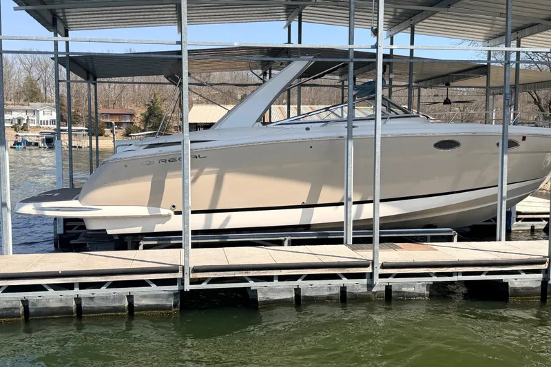 Slide: The Image of 2005 Regal 3350 Sport Cruiser docked under a covered marina. - 12