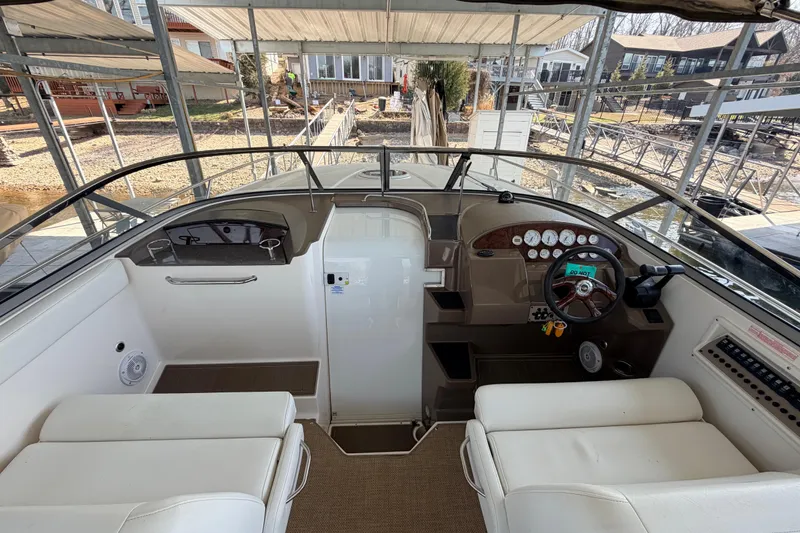 Slide: The Image of 2005 Regal 3350 Sport Cruiser cockpit with steering wheel and dashboard controls. - 15
