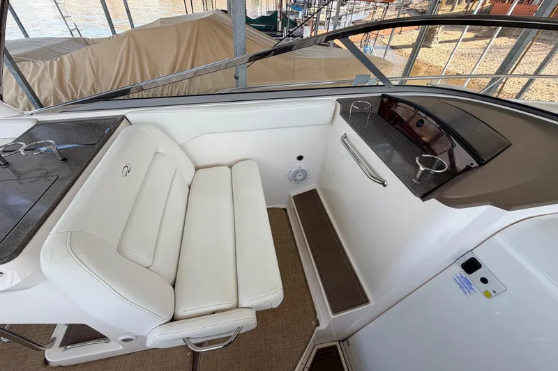 Slide: The Image of 2005 Regal 3350 Sport Cruiser interior with white seating and cup holders. - 17