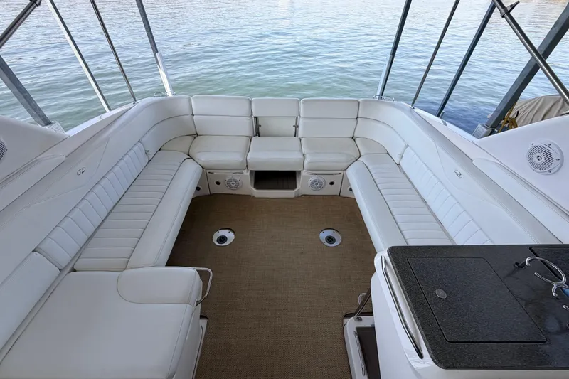 Slide: The Image of 2005 Regal 3350 Sport Cruiser interior with white seating and water view. - 19