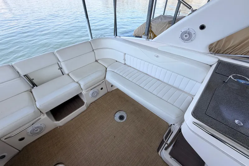 Slide: The Image of 2005 Regal 3350 Sport Cruiser interior with white seating and water view. - 20