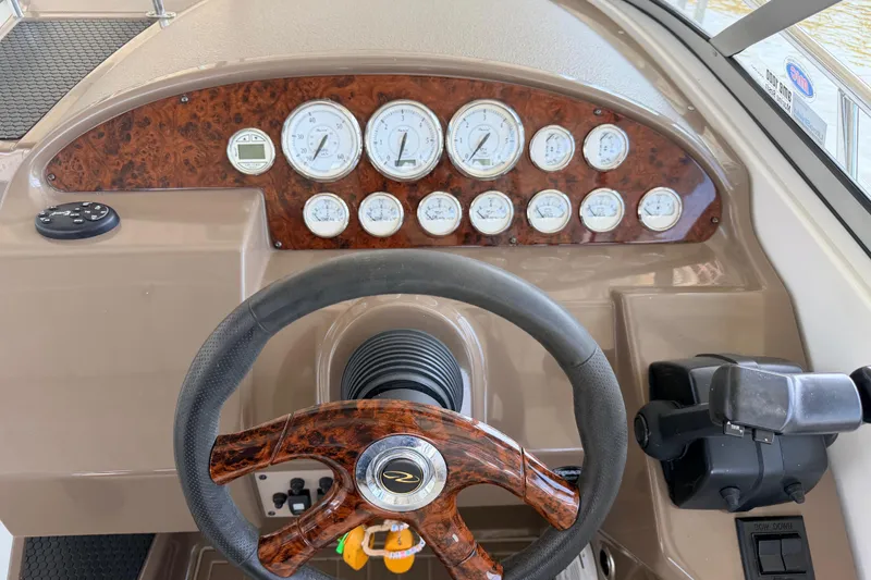 Slide: The Image of 2005 Regal 3350 Sport Cruiser dashboard with wood accents and steering wheel. - 21