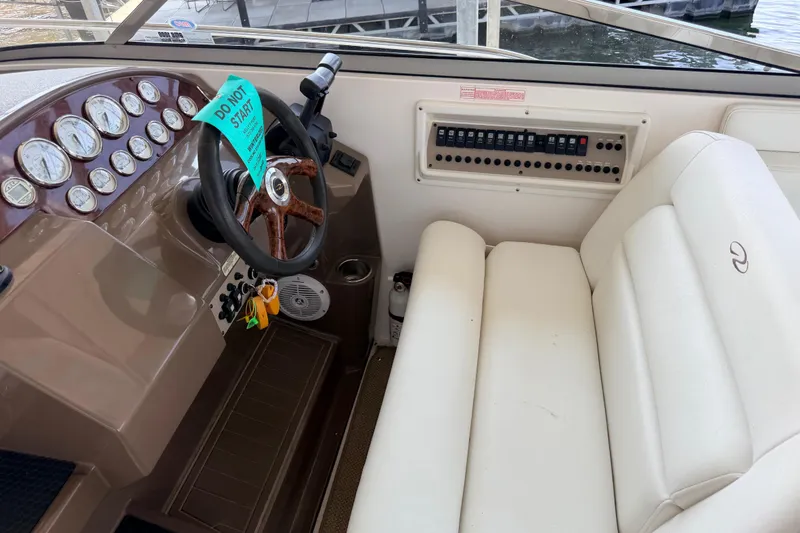 Slide: The Image of 2005 Regal 3350 Sport Cruiser helm with gauges, steering wheel, and control panel. - 22