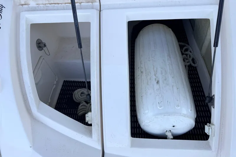 Slide: The Image of Storage compartments on a 2005 Regal 3350 Sport Cruiser with ropes and a fender. - 23