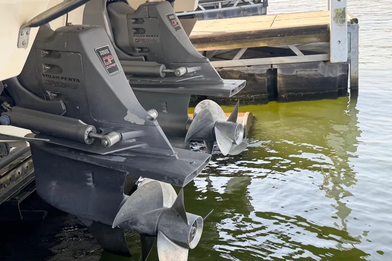 Slide: The Image of Twin Volvo Penta outdrives on a 2005 Regal 3350 Sport Cruiser at a dock. - 25