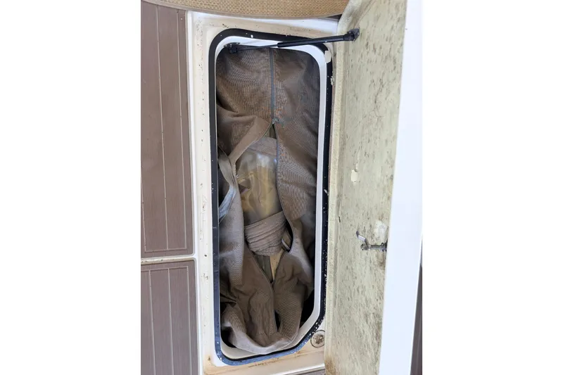 Slide: The Image of Storage compartment of a 2005 Regal 3350 Sport Cruiser with canvas cover inside. - 31