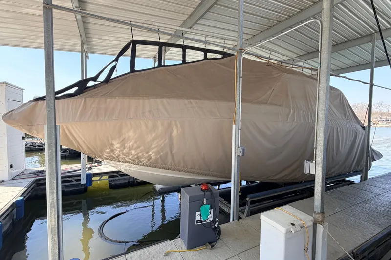 Slide: The Image of 2005 Regal 3350 Sport Cruiser covered and docked in a marina. - 33