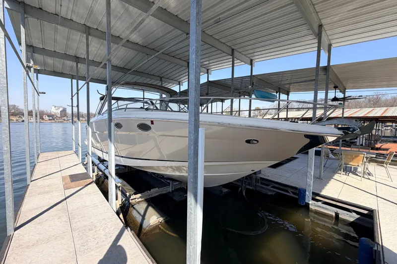 Slide: The Image of 2005 Regal 3350 Sport Cruiser docked under covered marina, side view. - 6