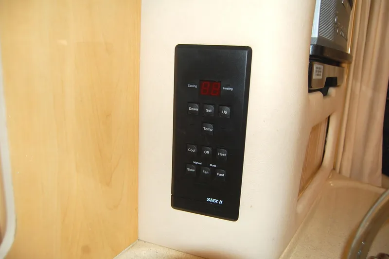 Slide: The Image of Control panel on 2000 Sea Ray 340 Sundancer yacht, featuring temperature and fan settings. - 12