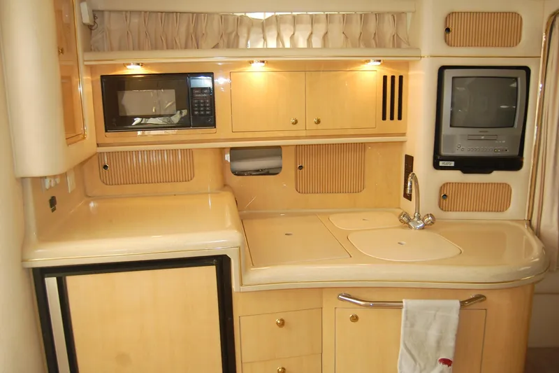 Slide: The Image of Interior of 2000 Sea Ray 340 Sundancer yacht with kitchenette, microwave, and TV. - 15