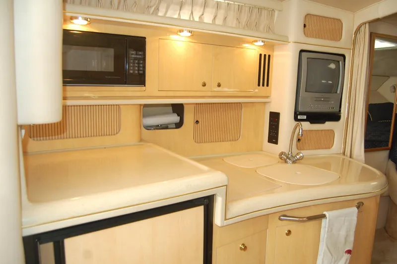 Slide: The Image of Interior of 2000 Sea Ray 340 Sundancer yacht with kitchenette and appliances. - 17