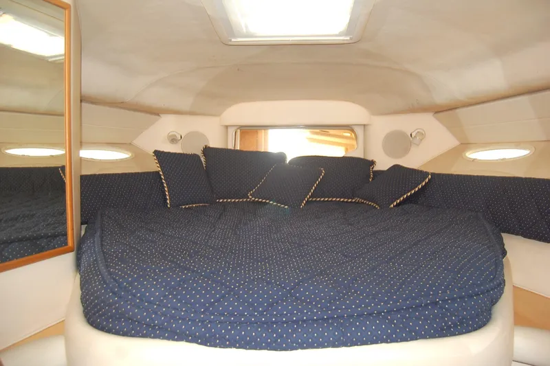 Slide: The Image of Cozy cabin interior of 2000 Sea Ray 340 Sundancer with blue bedding and pillows. - 21