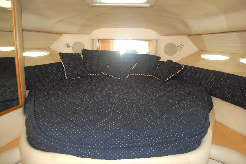 Slide: The Image of Interior cabin of 2000 Sea Ray 340 Sundancer with cozy bedding and pillows. - 22