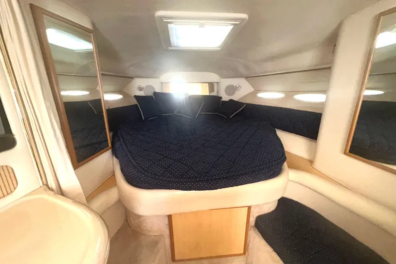 Slide: The Image of Interior cabin of 2000 Sea Ray 340 Sundancer with cozy bed and mirrors. - 23