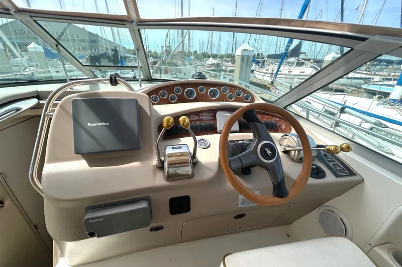 Slide: The Image of Cockpit of 2000 Sea Ray 340 Sundancer with steering wheel and navigation equipment. - 25