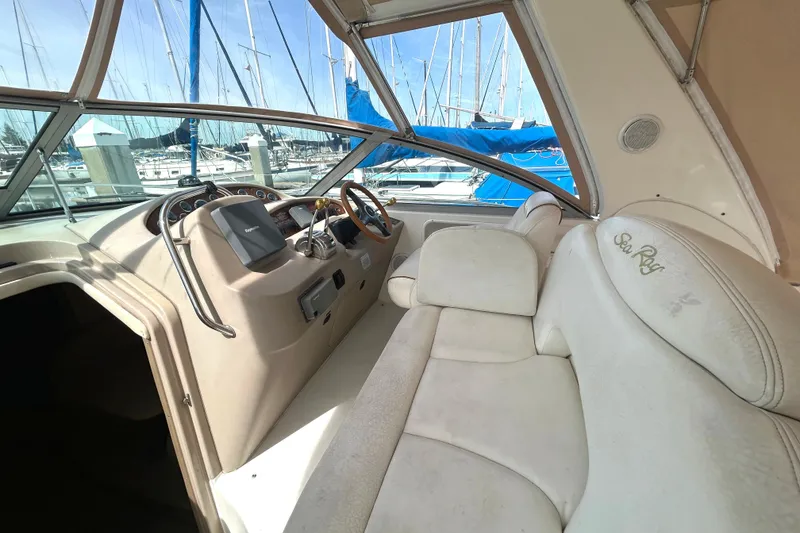 Slide: The Image of Interior of a 2000 Sea Ray 340 Sundancer yacht with white seating and helm. - 28