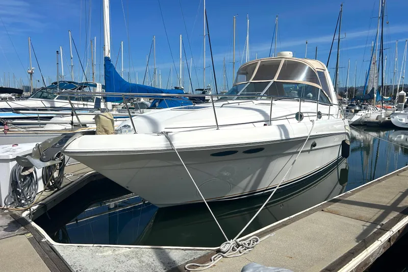 Slide: The Image of 2000 Sea Ray 340 Sundancer yacht docked at a marina under clear blue skies. - 3