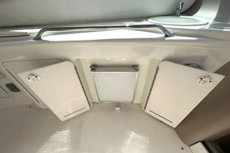 Slide: The Image of Interior view of a 2000 Sea Ray 340 Sundancer boat with open storage compartments. - 30