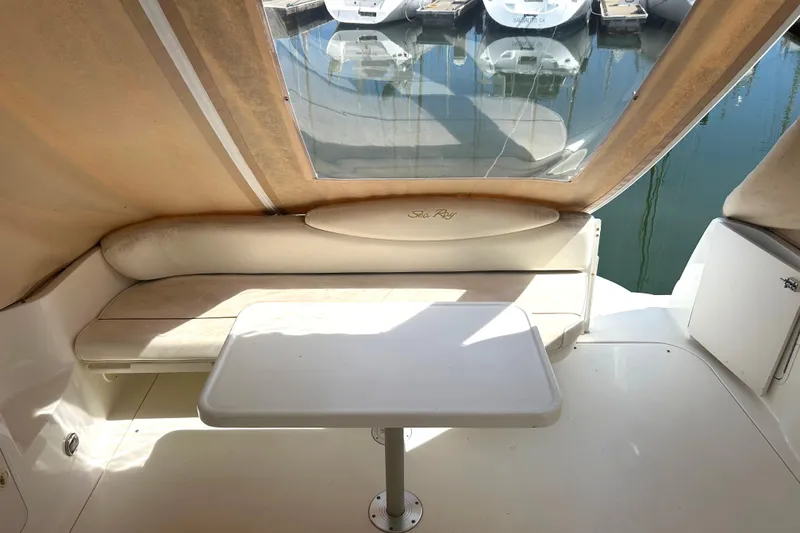 Slide: The Image of Interior of 2000 Sea Ray 340 Sundancer with seating and table, docked at marina. - 32