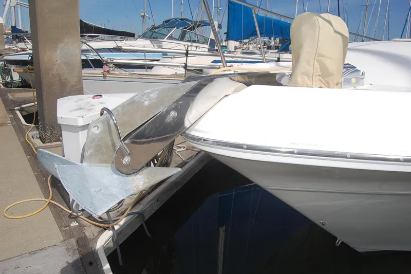 Slide: The Image of Sea Ray 340 Sundancer 2000 docked, featuring a large anchor and marina background. - 35