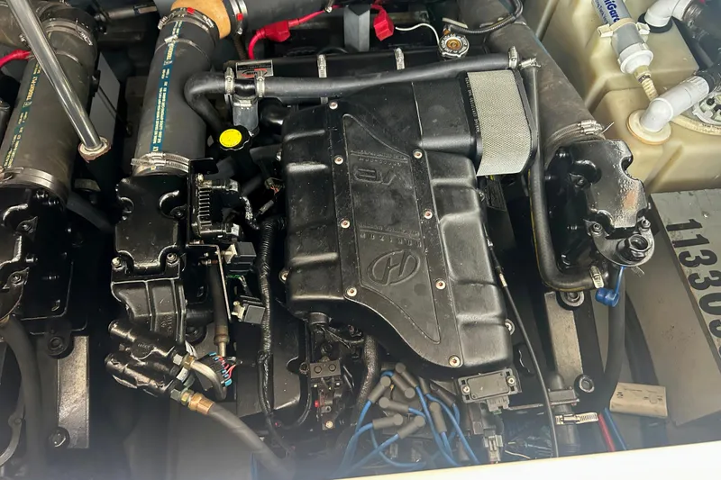 Slide: The Image of Engine compartment of a 2000 Sea Ray 340 Sundancer boat, showcasing mechanical components. - 38