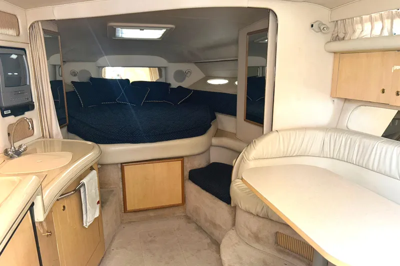 Slide: The Image of Interior of 2000 Sea Ray 340 Sundancer yacht with cozy seating and sleeping area. - 7