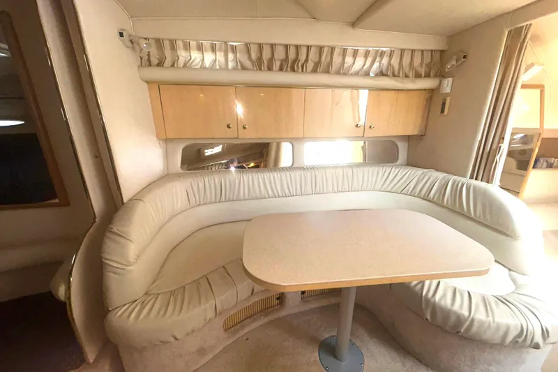 Slide: The Image of Interior of 2000 Sea Ray 340 Sundancer with curved seating and table. - 8