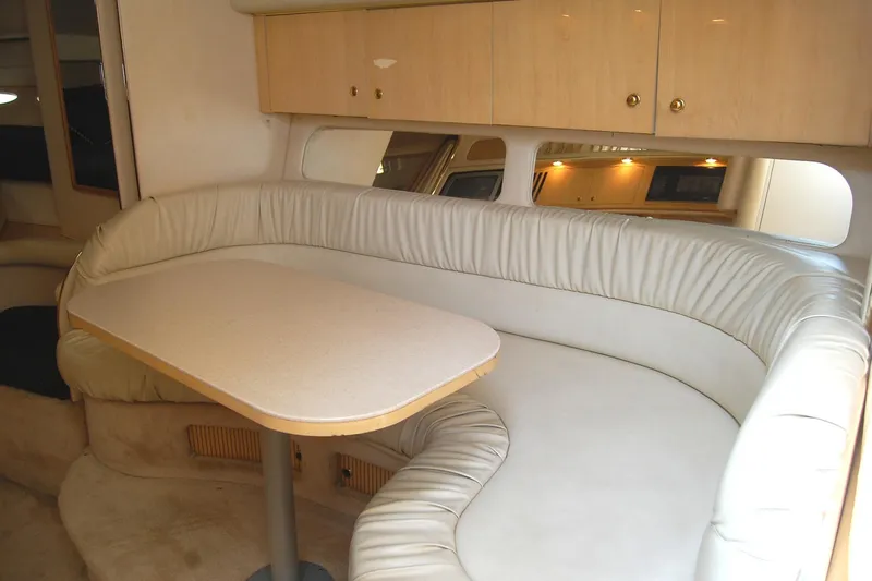 Slide: The Image of Interior of 2000 Sea Ray 340 Sundancer with curved seating and table. - 9