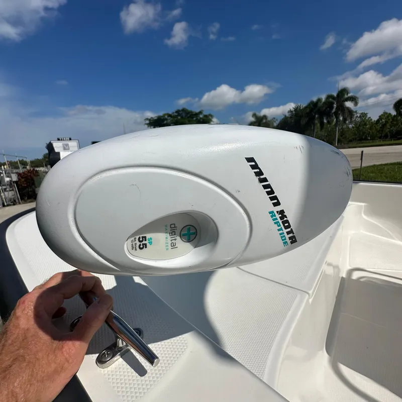 Slide: The Image of Minn Kota trolling motor on 2014 Boston Whaler 150 Montauk boat under clear sky. - 11