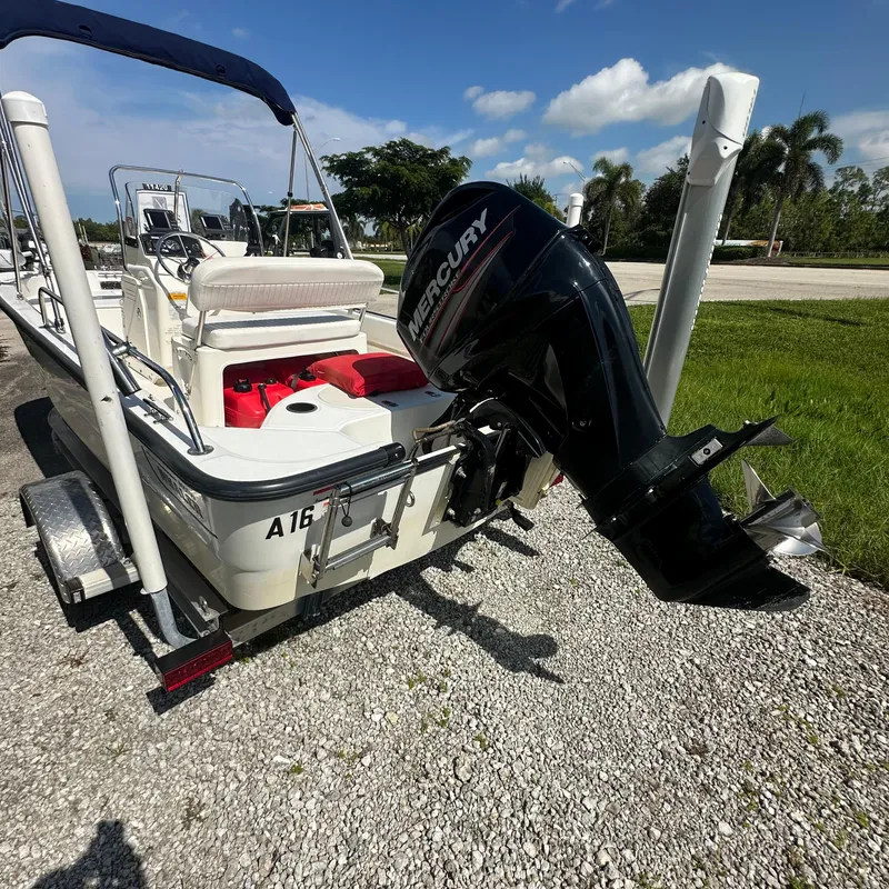 Slide: The Image of 2014 Boston Whaler 150 Montauk boat with Mercury outboard motor on trailer. - 16