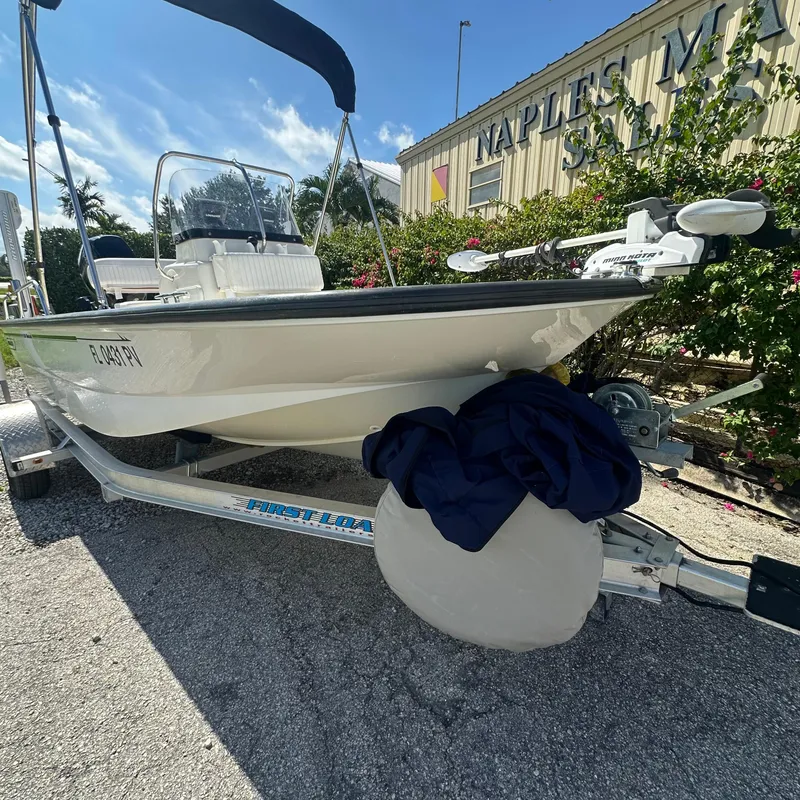Slide: The Image of 2014 Boston Whaler 150 Montauk boat on trailer, parked outside Naples Marine Sales. - 3