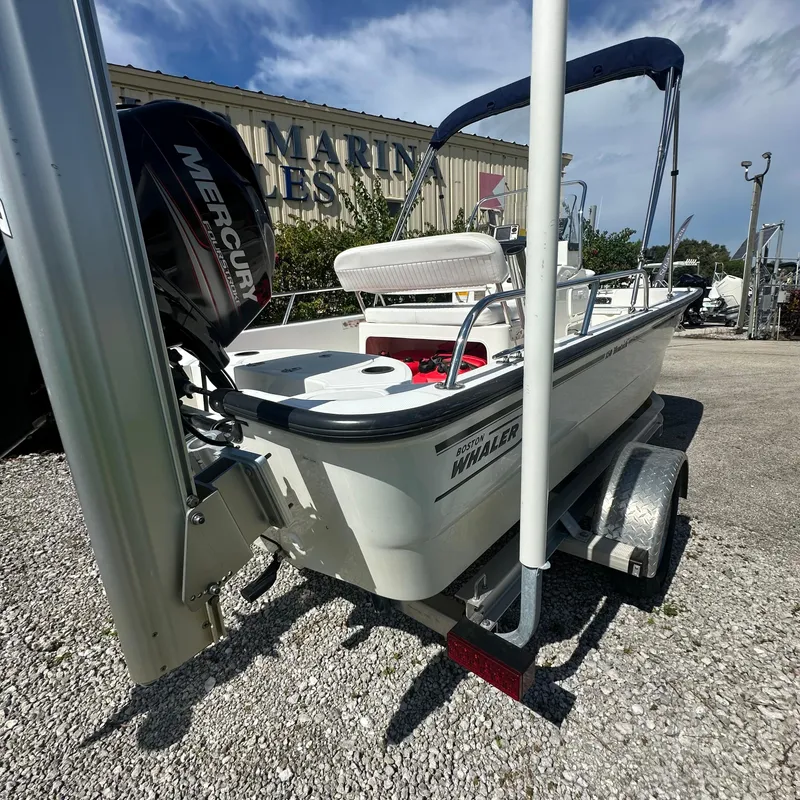 Slide: The Image of 2014 Boston Whaler 150 Montauk boat on trailer with Mercury engine. - 5