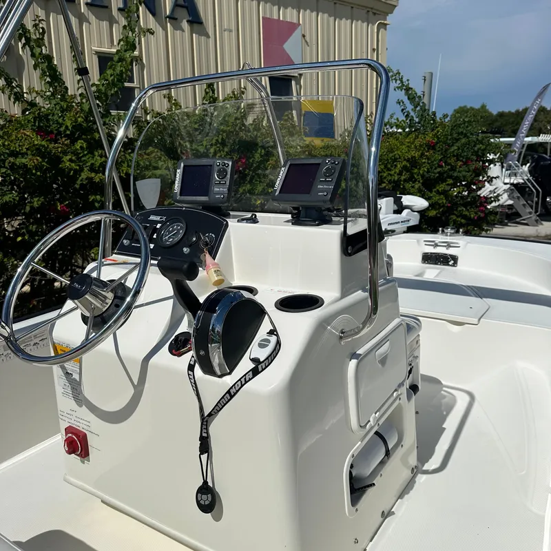 Slide: The Image of 2014 Boston Whaler 150 Montauk boat console with steering wheel and navigation equipment. - 7