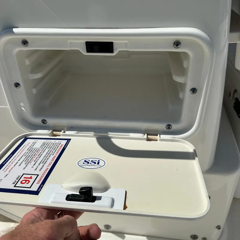 Slide: The Image of Open storage compartment on a 2014 Boston Whaler 150 Montauk boat. - 8