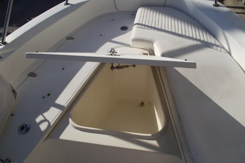 Slide: The Image of 2011 Boston Whaler 230 Dauntless boat interior storage compartment with open lid. - 10
