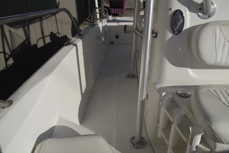 Slide: The Image of 2011 Boston Whaler 230 Dauntless interior with white seating and stainless steel railings. - 11