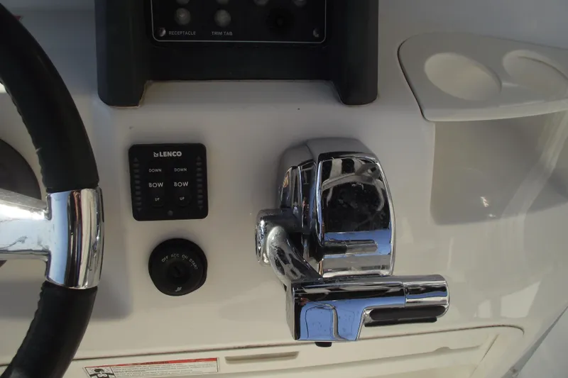 Slide: The Image of Control panel of a 2011 Boston Whaler 230 Dauntless boat with steering wheel and throttle. - 16