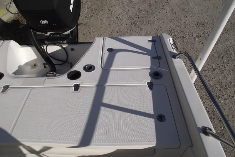 Slide: The Image of 2011 Boston Whaler 230 Dauntless boat deck with storage compartments and motor. - 20