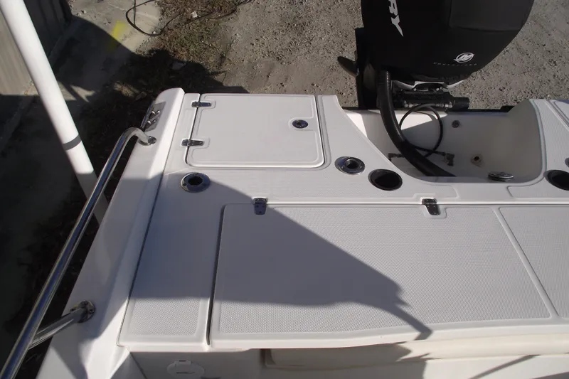 Slide: The Image of 2011 Boston Whaler 230 Dauntless boat deck with storage compartments and railing. - 21