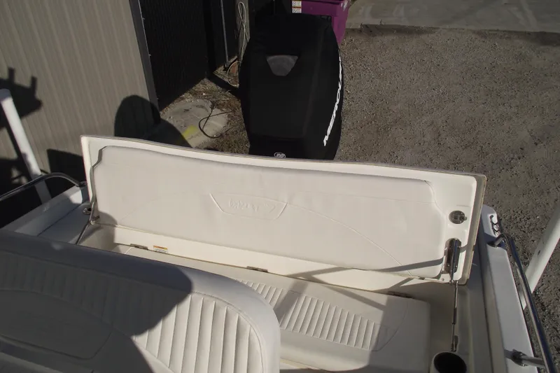 Slide: The Image of 2011 Boston Whaler 230 Dauntless boat interior with white seating and storage compartment. - 22