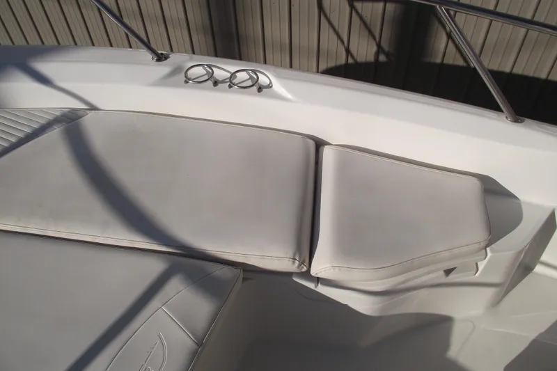 Slide: The Image of Boston Whaler 230 Dauntless 2011 boat seating area with cup holders and railing. - 7