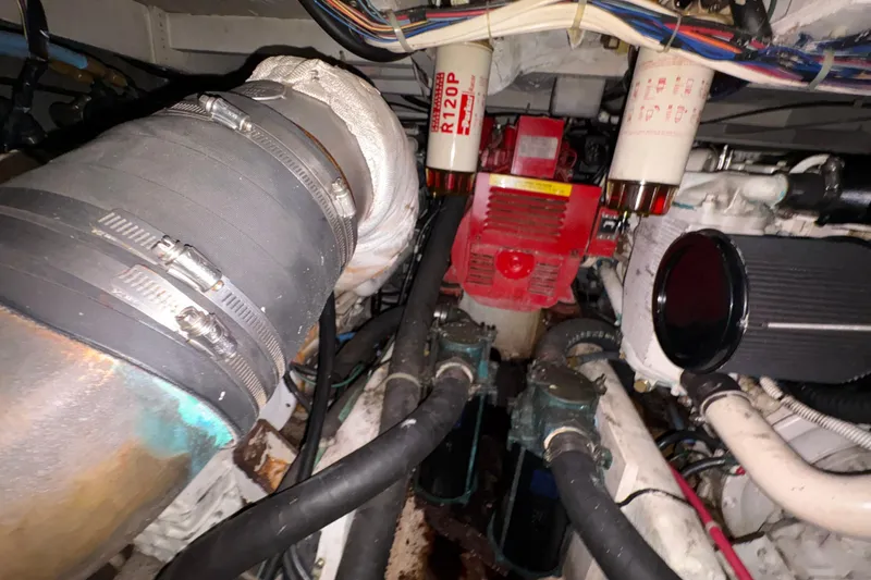 Slide: The Image of Engine room of 1988 Bayliner 3587 Motoryacht with visible filters and hoses. - 102