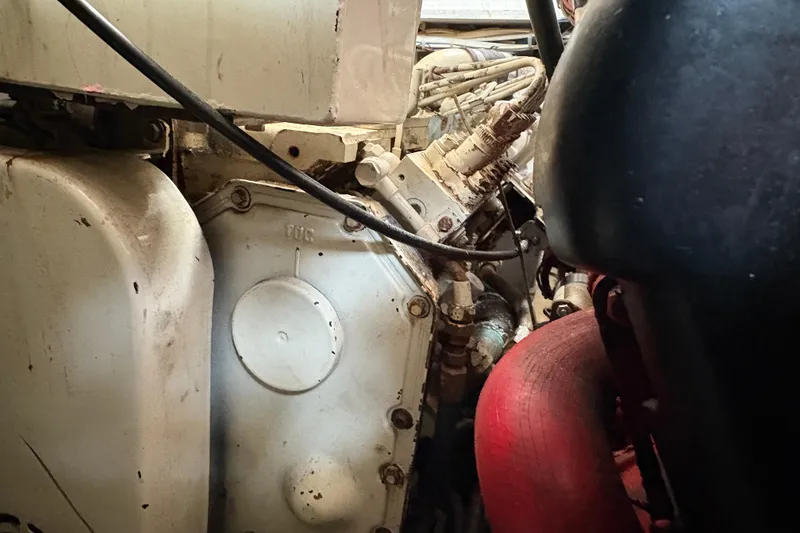 Slide: The Image of Engine compartment of a 1988 Bayliner 3587 Motoryacht, showing mechanical components and wiring. - 109