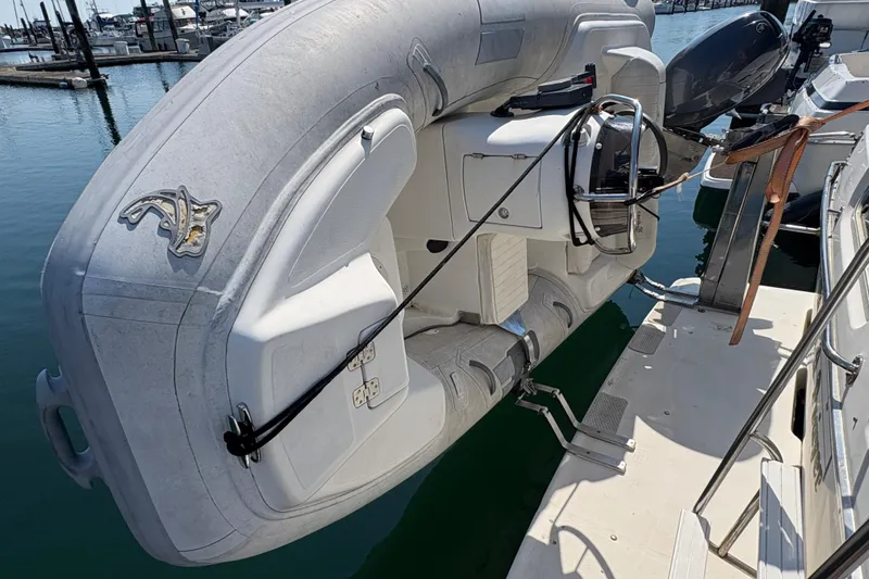 Slide: The Image of 1988 Bayliner 3587 Motoryacht with attached inflatable dinghy at marina. - 11