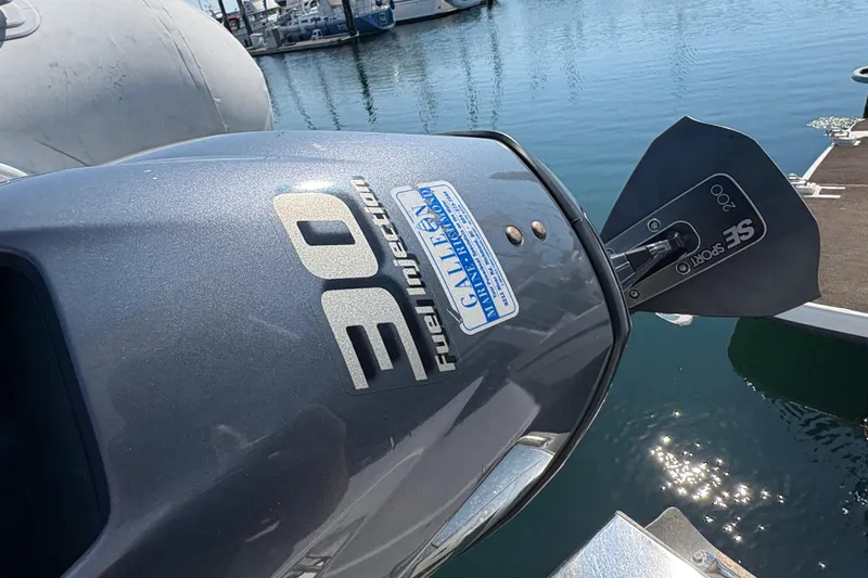 Slide: The Image of Outboard motor on a 1988 Bayliner 3587 Motoryacht, docked at a marina. - 13