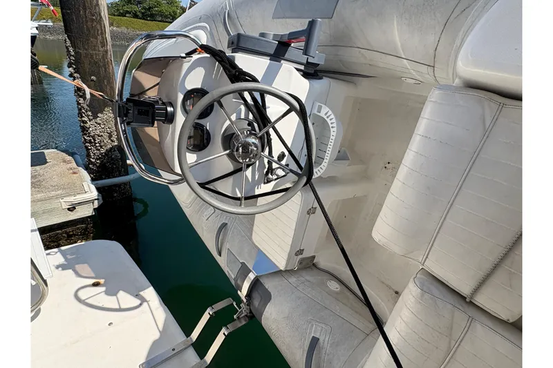 Slide: The Image of 1988 Bayliner 3587 Motoryacht steering wheel and controls, docked by the water. - 17