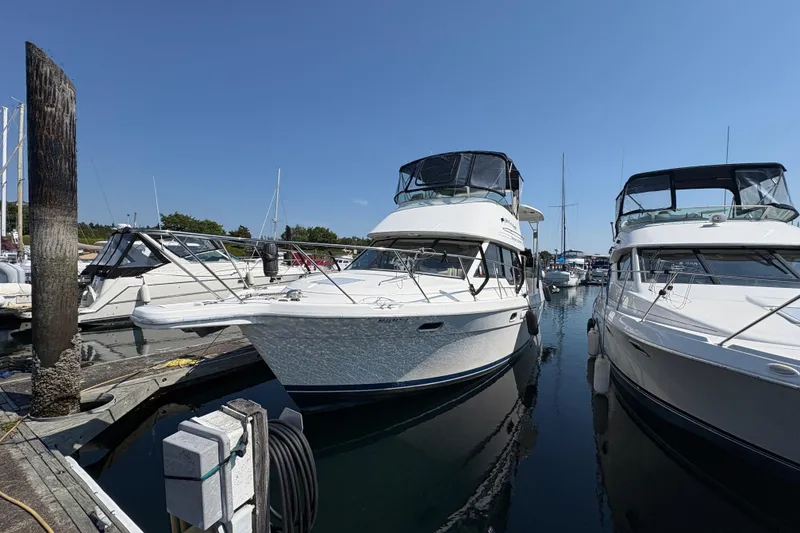 Slide: The Image of 1998 Bayliner 3587 Motoryacht docked at marina on a sunny day. - 21
