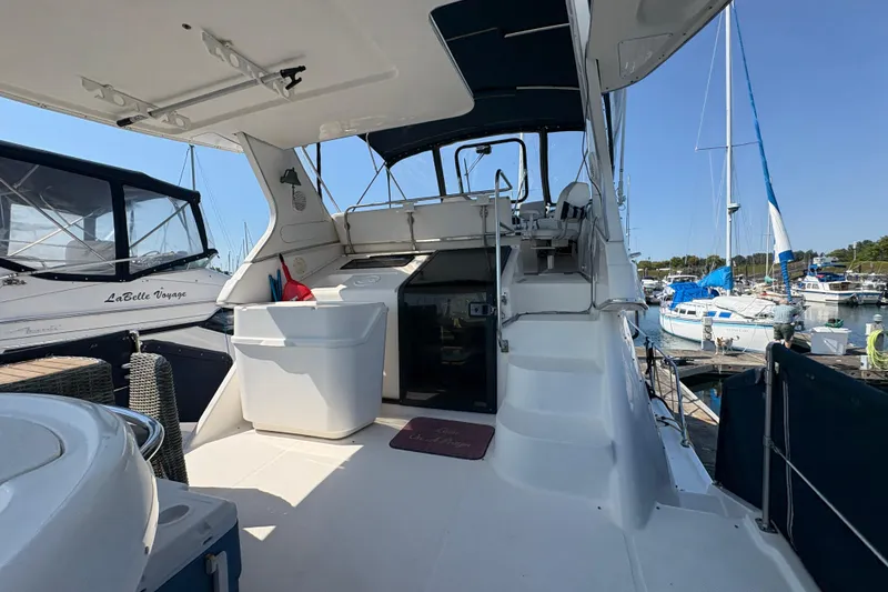 Slide: The Image of 1988 Bayliner 3587 Motoryacht interior with marina view, featuring seating and helm area. - 22