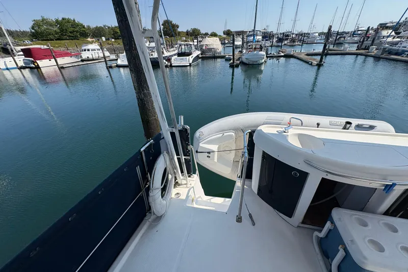 Slide: The Image of 1988 Bayliner 3587 Motoryacht docked at marina, surrounded by calm water and other boats. - 24